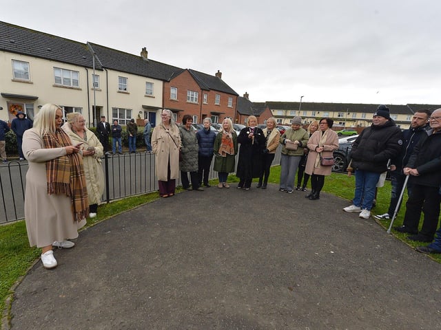 Shannon Canning (on the left), one of the organisers, speaking before the unveiling of a bench, in Culdaff Gardens, Creggan, in memory of Annette McDaid. Photo: George Sweeney