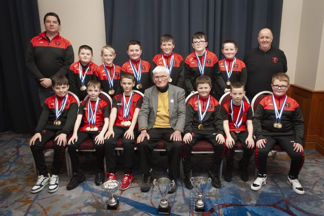 John ‘Jobby’ Crossan pictured with the Phoenix Athletic U11 team, winners of the Summer and Winter Cups and the D&D League, during the Annual Awards in the City Hotel on Friday night last. Included are coaches Patsy McNaught and Rob McNulty.