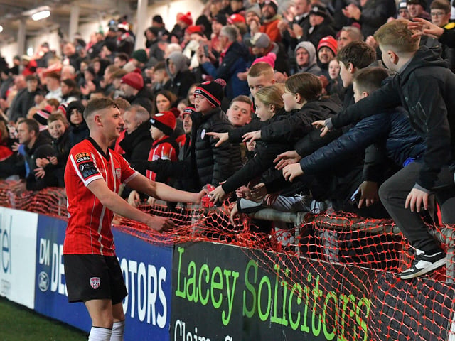 Ronan Boyce gives a Derry City shirt to a young fan. Photograph: George Sweeney