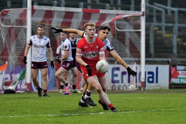 Derry’s Declan Cassidy holds off Sean Fitzgerald of Galway during Saturday’s encounter at Celtic Park. Photo:  George Sweeney