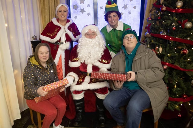 Amanda Dillon and Donal Donnelly pose with Santa for a picture at Santa Saturday in Derry Credit Union. : .