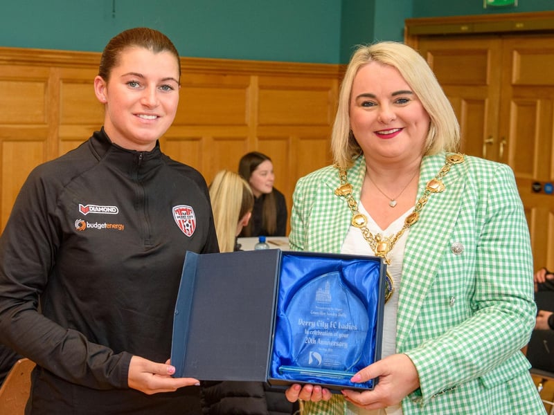 The Mayor Councillor Sandra Duffy pictured with Derry City Ladies Football team as she hosted a reception to mark their 20th anniversary. During the event the First Citizen presented a commemorative gift to captain, Shannon Dunne. The team were joined by coach Paul Dixon and Chairperson John Hegarty. Picture Martin McKeown. 05.05.23