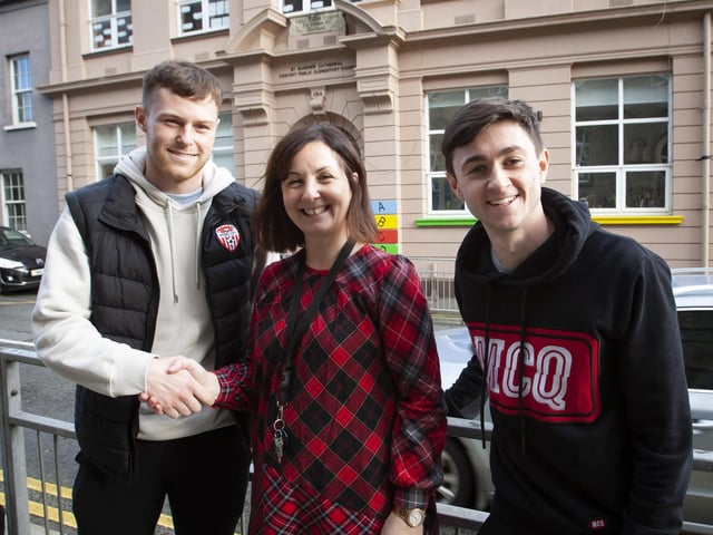 Principal, Mrs Carol Duffy welcomes Derry City pair Cameron McJannet and Declan Glass to St. Eugene's Primary School on Tuesday afternoon.