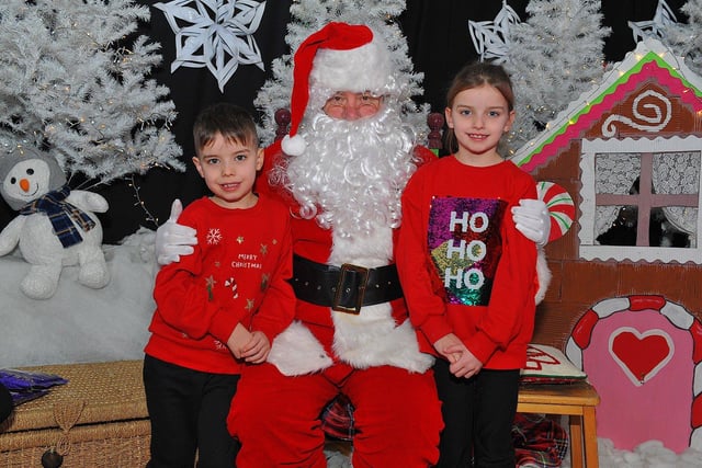 Twins Noah and Mya from Mrs Coyle’s P4 class at St Eithne’s Primary School pictured with Santa during his visit on Friday. Photo: George Sweeney. DER2250GS – 54