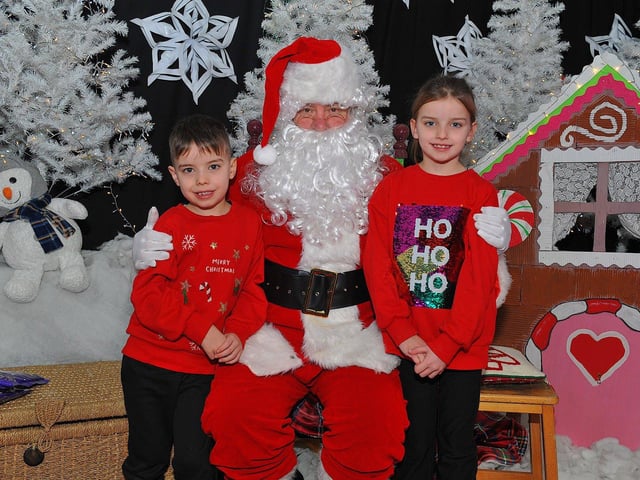 Twins Noah and Mya from Mrs Coyle’s P4 class at St Eithne’s Primary School pictured with Santa during his visit on Friday. Photo: George Sweeney. DER2250GS – 54