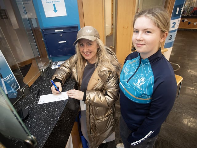 CU member Amanda Murphy signing up for the Credit Union's Prize Draw during Saturday's festivities. : .