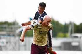 BRANDYWELL-BOUND? . . .  Hearts striker Liam Boyce holds off Falkirk's Dylan Tait.
