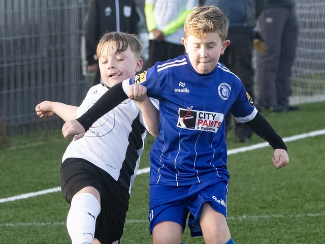 A battle for possession during Saturday's 2015s Sean O'Kane Memorial Cup between Letterkenny Rovers and Trojans at St. Joseph's Boys School.