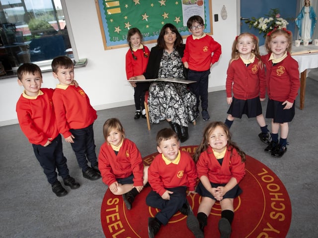TRIPLETS AND TWINS!. . . . . Steelstown PS new Principal Mrs. Catherine Doorish pictured with some of this year's intake of Primary One pupils which includes, triplets - (front centre) Blair, Saul and Alexandra, and from left, twins - Callum and Caolan, Abigail and Aiden, and Eadan and Ruadh. (Photos: Jim McCafferty Photography):.