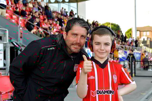 A young fan has a picture taken with Derry City manager Ruaidhri Higgins before the game against Shelbourne on Friday night. Photo: George Sweeney. DER2321GS - 70