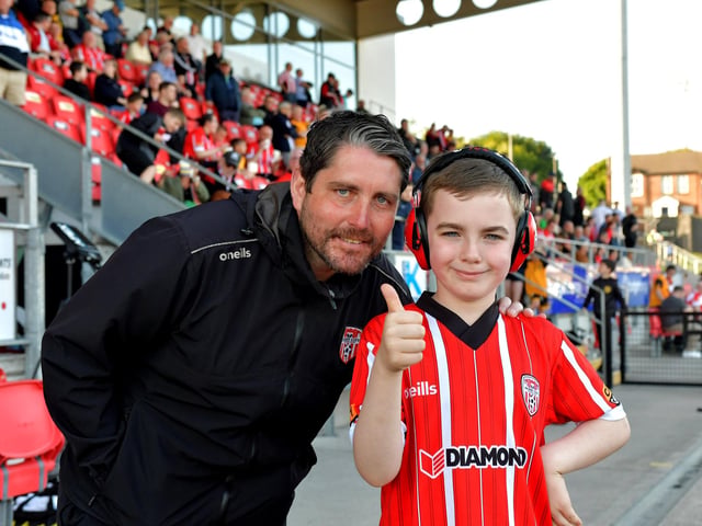 A young fan has a picture taken with Derry City manager Ruaidhri Higgins before the game against Shelbourne on Friday night. Photo: George Sweeney. DER2321GS - 70