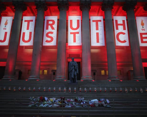 A banner reading Truth and Justice is hung from Liverpool's Saint George's Hall and illuminated in red after the Hillsborough inquest verdict on April 26, 2016 (Photo by Christopher Furlong/Getty Images)