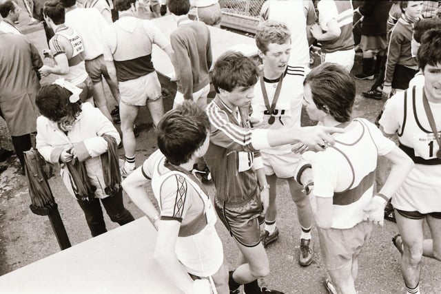 These runners discuss the course after receiving their medals at the Male Mini Marathon in 1983.