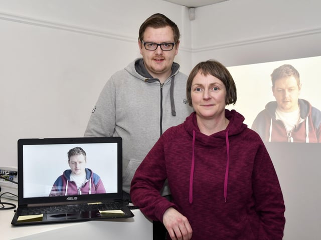 Judi Logue, curator, pictured with Johnny Scanlon whose work featured in the 'Through Your Lens' multimedia exhibition in the Eden Place Arts Centre. The exhibition was organised as part of a project by Community Dialogue and Youth Action NI for young people who were born around the time of the signing of the Good Friday Agreement 20 years ago. DER0218-122KM