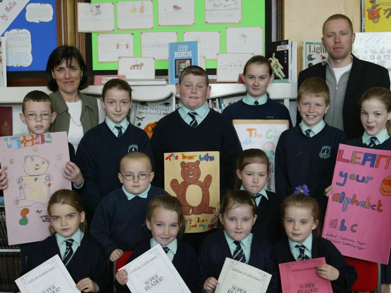 Longtower PS pupils who participated in a Peered reading programme.  Included in photo are seated Nadia Kelly, Saoirse McDermott, Amy Robinson and Jodie Doherty. Standing are Patrick Harkin, Aoife Stewart, Daniel Carlin, Michael Smith, Kayleigh Robinson, Sian McClean, Stephen McCool, Catherine Taylor.  Also in photo are Joyce Logue (Literacy co-ordinator) and P7 teacher Gareth Blackery.  (1605JB03) 