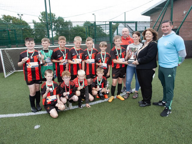 Phoenix Athletic FC captain Harrison Moore receiving the Padraig Barton Memorial Cup 2023 from the Mayor, Patricia Logue at Bay Road last week. Included are Kieron Kehoe, coach, Aine Barton and Collie Kelly, tournament organiser. The event was part of Feile 23. (Photos: Jim McCafferty Photography)