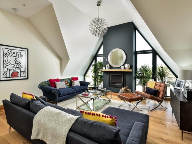 The first floor sitting room is a stunning and naturally bright living space with views over the garden and beyond and has vaulted ceilings, a log burning stove and large windows.