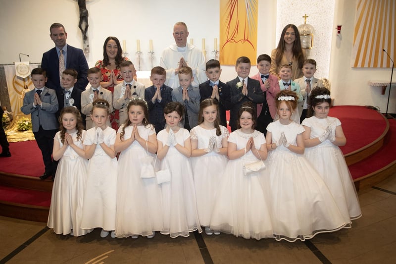 Pupils from Mrs. Vance's class at Greenhaw Primary School who received the Sacrament of First Holy Communion from Fr. Sean O'Donnell at St. Brigid's Church, Carnhill on Friday last. Included are Mr. Sean McLaughlin, Principal and Miss Coyle, teaching assistant. (Photo: Jim McCafferty Photography)