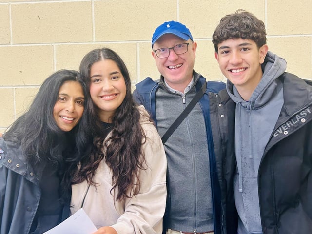 A smiling Sophia Mc Ginnis sharing her fantastic A Level oucomes with her parents and brother.