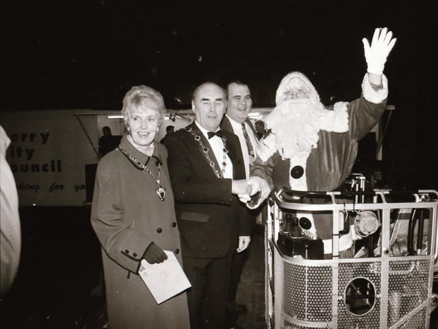 Crowds watch as Mayor and Mayoress of Derry, John and Carita Kerr switch on the Christmas lights with a little help from Spider Man and the Power Rangers.