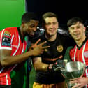 Derry City players Sadou Diallo, Brian Maher and Adam O’Reilly with the President’s Cup after their victory over Shamrock Rovers at the Brandywell .