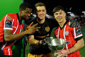 Derry City players Sadou Diallo, Brian Maher and Adam O’Reilly with the President’s Cup after their victory over Shamrock Rovers at the Brandywell .