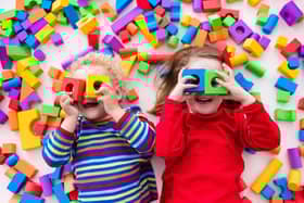 Happychildren play with colorful plastic toy blocks. Picture: famveldman - stock.adobe.com.