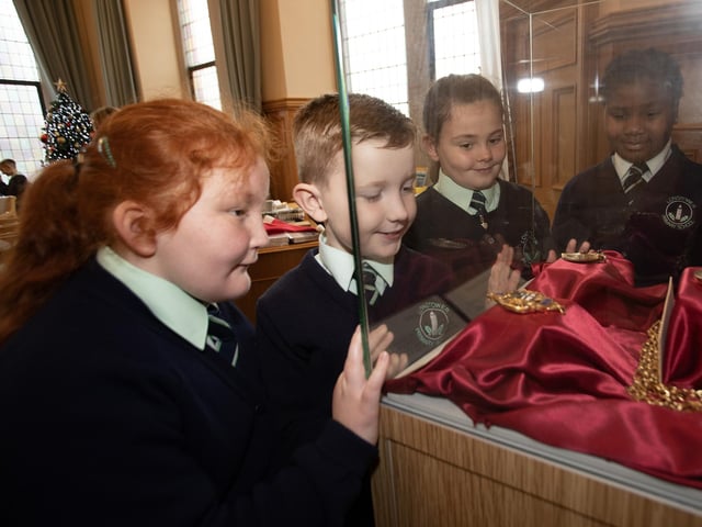 Pupils from the Long Tower Primary School looking at some of the older chains of office in the Mayor's Parlour, Guildhall during their Democracy Week visit on Thursday last.
