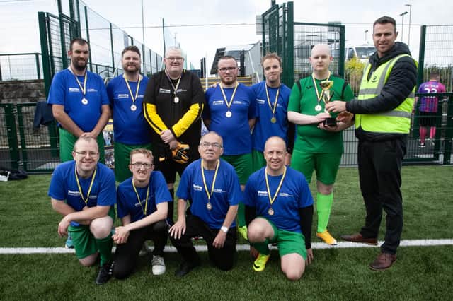 PEACE GAMES CHAMPIONS 2023. . . .Chris Cooper, manager, Foyle Down Syndrome Trust, pictured handing over the 2023 Peace Games trophy to winners, Destined FC at the Waterside Shared Village pitches on Friday afternoon. (Photos: Jim McCafferty Photography)