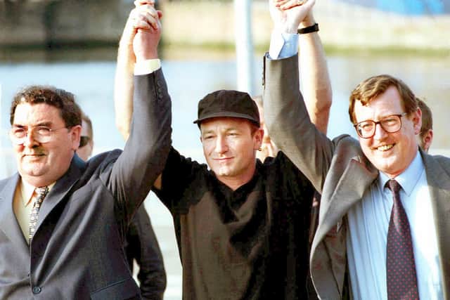 Bono raising the arms of John Hume and David Trimble aloft in 1998.