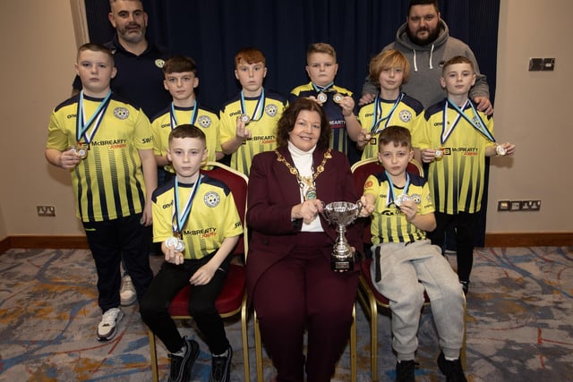 The Mayor, Patricia Logue, pictured at the D&D Youth FA Annual Awards at the City Hotel on Friday night presents Sion Swifts U12s with the Winter Cup. Included are coaches Donal Grant and James McMenamin.