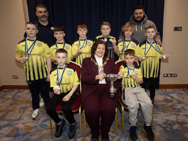 The Mayor, Patricia Logue, pictured at the D&D Youth FA Annual Awards at the City Hotel on Friday night presents Sion Swifts U12s with the Winter Cup. Included are coaches Donal Grant and James McMenamin.