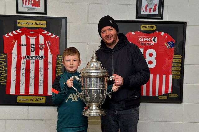 Derry City fans Cahir Doran (9) and his dad Sean pictured with the FAI Cup at the Ryan McBride Brandywell Stadium on Thursday evening last.