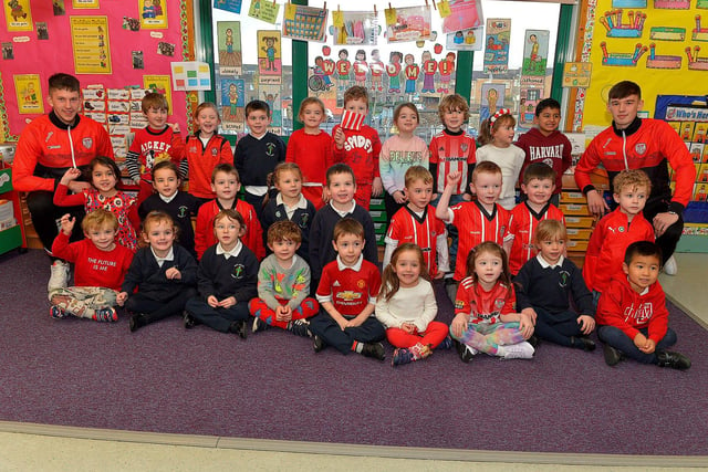 Derry City’s Jack Lemoignan and Liam Mullan pictured with Mrs McKinney's P1 class during a visit to Good Shepherd Primary School on Friday afternoon. Photo: George Sweeney. DER2247GS – 62