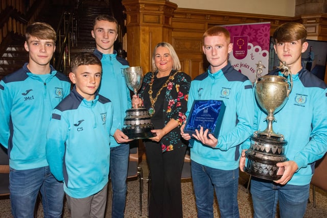 The Mayor Councillor Sandra Duffy pictured with Jack McIvor, Charlie Simpson, Charlie Downey, Sam Stott and Sam McClintock  with the Premier Division and Faughan Valley trophies.