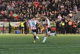 Jacob Davenport congratulates Derry City goal scorer Pat Hoban. Photograph: George Sweeney
