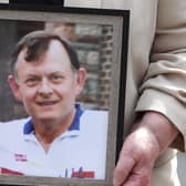 File photo dated 13/06/23 of Bridie Brown, the widow of murdered GAA official Sean Brown, holding a picture of him, outside the Royal Courts of Justice in Belfast. The UK Government has been ordered to hold a public inquiry into his murder. No-one has ever been convicted of his murder. Issue date: Tuesday December 17, 2024.