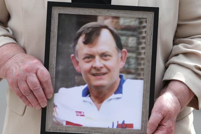 File photo dated 13/06/23 of Bridie Brown, the widow of murdered GAA official Sean Brown, holding a picture of him, outside the Royal Courts of Justice in Belfast. The UK Government has been ordered to hold a public inquiry into his murder. No-one has ever been convicted of his murder. Issue date: Tuesday December 17, 2024.
