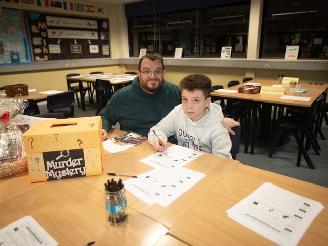 Drumahoe PS pupil Ruben McGeady and his dad taking part in the 'Murder Mystery' competition during a visit to the Maths Department.