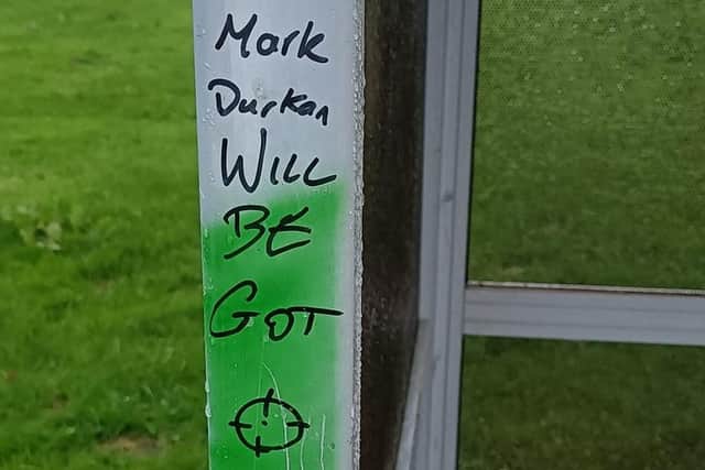 A threat against Mark H. Durkan was daubed on a bus shelter in Strathfoyle.