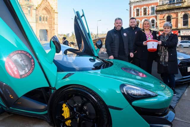 The Mayor Councillor Sandra Duffy pictured with Gary and Stephen McCaul and Eileen Best from this years Mayoral Charity, First Housing Aid and Support Services as they launch Supercar Saturday which is taking place on the 13th of May. Two of the stars which will be on display are a Maclaren and an Audi RS7. Picture Martin McKeown. 14.03.23
