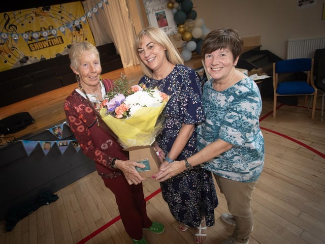 Retiring Principal of Model PS Mrs. Michelle Ramsey receives a bouquet of flowers from Daisy Mules and Lesley Hamilton, Board of Governors.