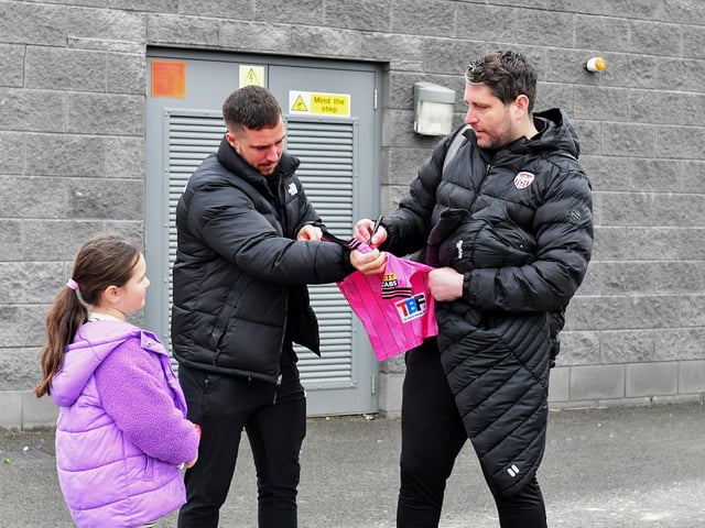 Derry City’s manager Ruaidhrí Higgins signs a shirt for a young fan on Saturday morning prior to the team’s departure for Dublin ahead of Sunday’s FAI Cup Final against Drogheda United. Photograph: George Sweeney