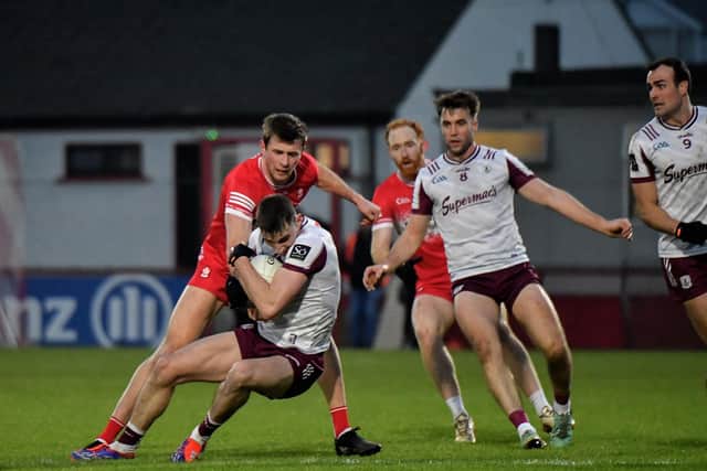 Derry’s Anton Tohill contests possession with Galway’s Matthew Tierney. Photo: George Sweeney