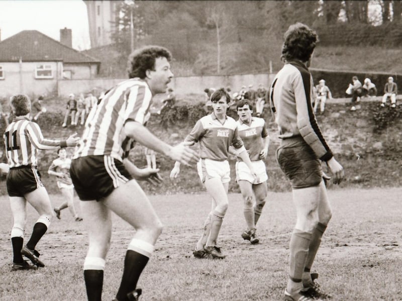 Derry City in action as fans watch on.