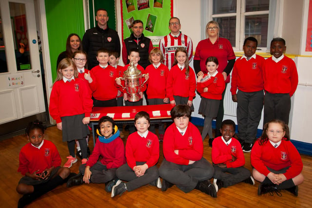 P5 pupils at St. Eugene’s PS show their support for Derry City on Monday last as players Shane McEleney and Joe Thompson brought the FAI Cup to the school.