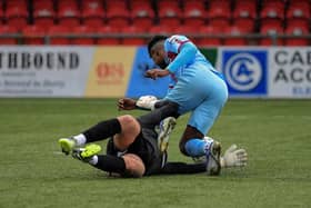 Portadown’s keeper Aaron Hogg brings down Institute’s BJ Banba.  Photo: George Sweeney