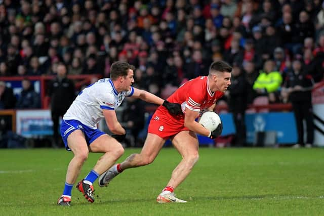 Conor Doherty shields the ball from Monaghan’s Stan Wylie. Photo: George Sweeney