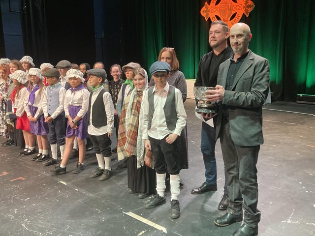 Editor of the Derry Journal, Brendan McDaid who presented the Derry Journal Cup to the winners of the Action Song (under eight) to the winning entrants, St Anne’s Primary School at Feis Dhoire Cholmcille. St Anne’s performed ‘Finnegan’s Wake.’ Pictured beside Brendan is adjudicator Darren Hargan who awarded a mark of 95. 33 Picture: Derry Feis.