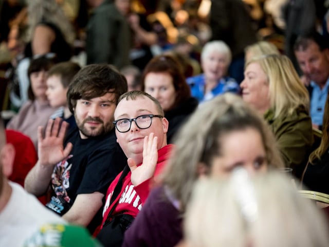 These audience members spot the photographer.